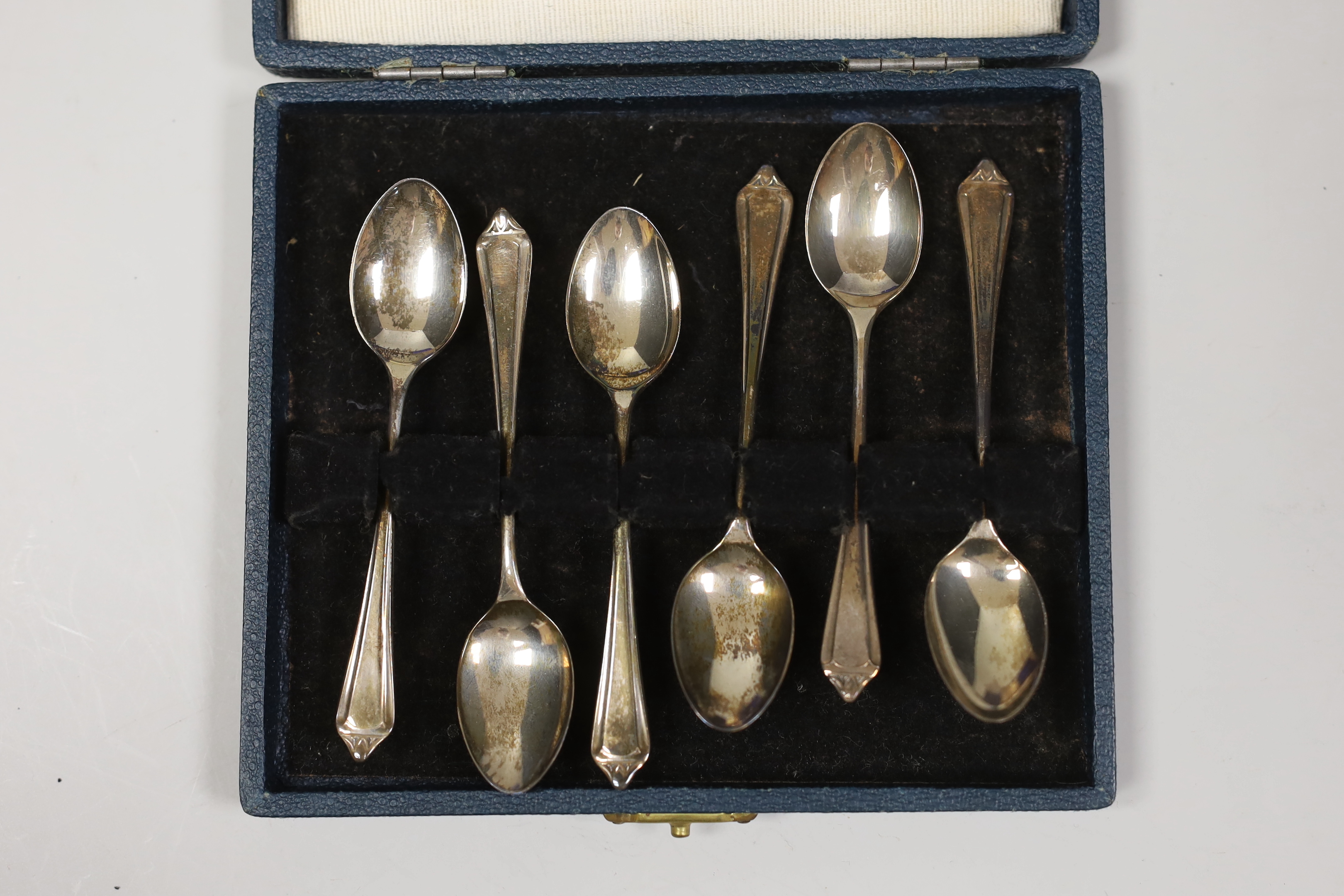 Three assorted cased sets of six silver tea or coffee spoons, one with tongs and other incomplete set.